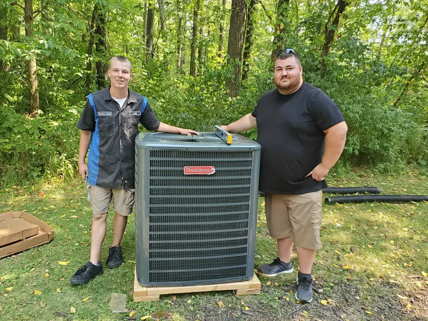 Our technicians with a new heat pump ready to install