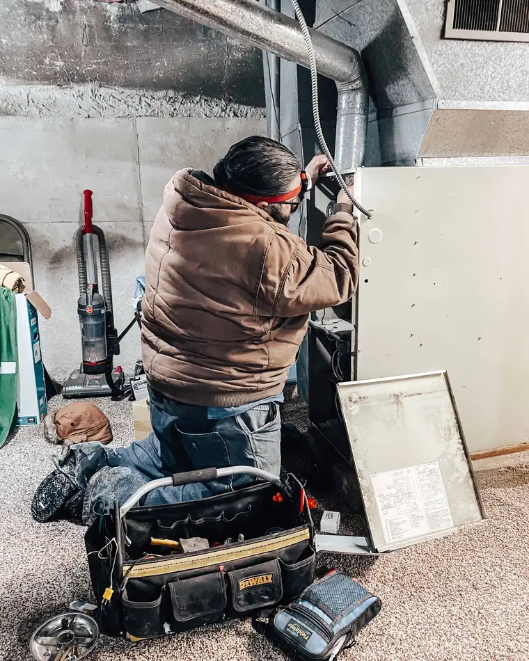 Technician servicing a furnace on a call in Huntington